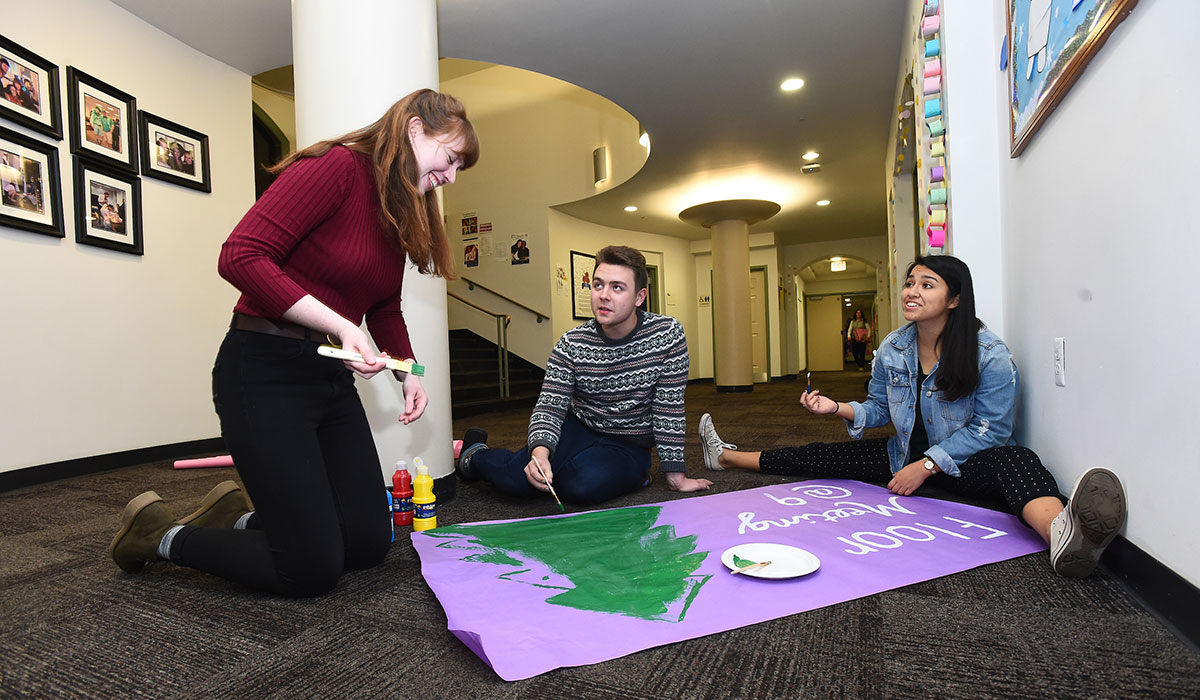 Students working on a banner in residence hall